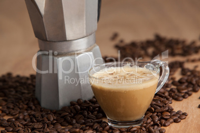 Coffee beans with metallic coffee maker and coffee cup
