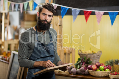 Worker writing on the board at the grocery store