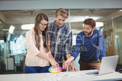 Graphic designers interacting with each other while working