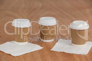 Three disposable coffee cup with tissue paper