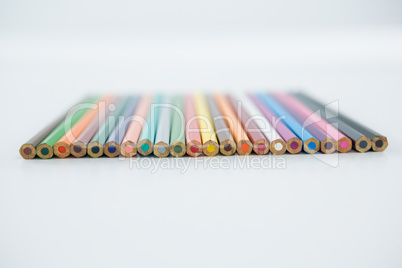 Colored pencils arranged in a row