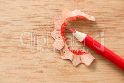 Close-up of red color pencil with pencil shaving