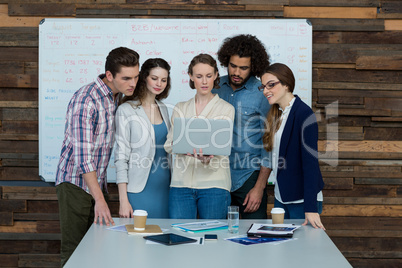 Business team discussing over laptop in meeting