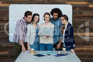 Business team discussing over laptop in meeting