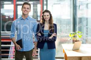 Smiling business executives standing in office