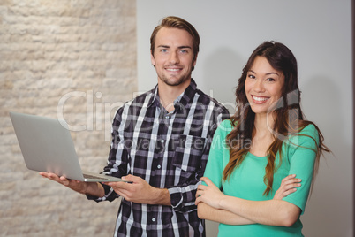 Male and graphic designers holding laptop