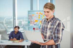 Male business executive using laptop