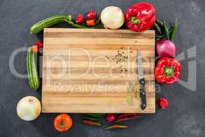 Vegetables around wooden board
