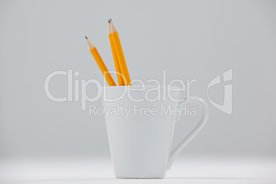 Three pencils kept in cup