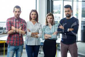 Portrait of businesspeople standing with arms crossed