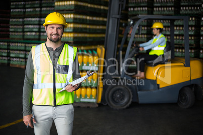 Portrait of factory worker holding clipboard