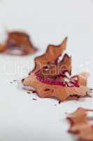 Red colored pencil shavings on white background