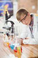 Attentive schoolboy doing a chemical experiment in laboratory