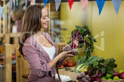 Woman choosing vegetables in grocery store
