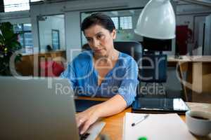 Female graphic designer using laptop
