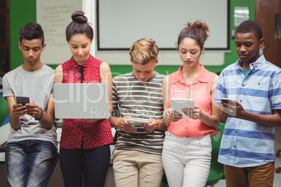 Students using laptop, mobile phone, digital tablet