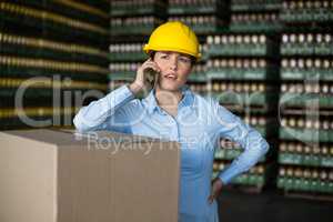 Female factory worker talking on mobile phone