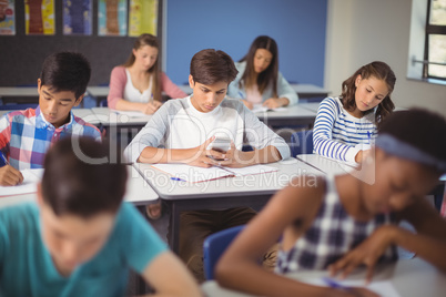 Student using mobile phone in classroom
