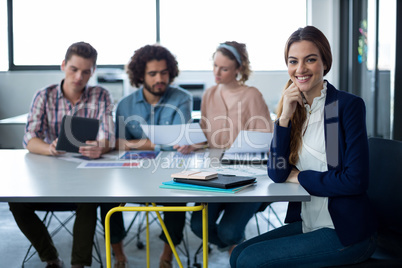 Portrait of female business executive sitting at desk
