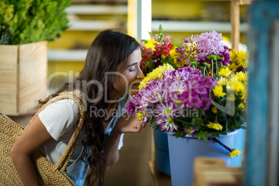 Woman smelling a bunch of flowers