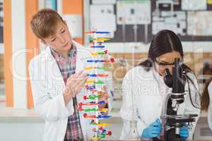 School kids experimenting molecule model in laboratory