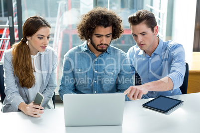 Business executive discussing over laptop in meeting