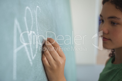 Attentive schoolgirl pretending to be a teacher in classroom