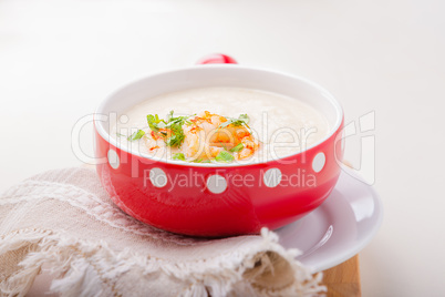 A bowl of creamy cauliflower soup with shrimps.