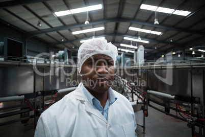 Factory engineer standing in bottle factory