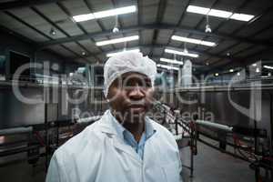 Factory engineer standing in bottle factory