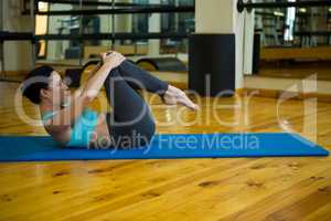 Beautiful woman performing stretching exercise