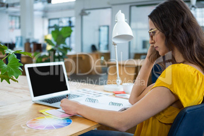 Female graphic designer working at desk