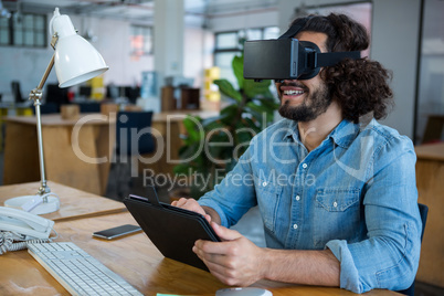Graphic designer using the virtual reality headset and digital tablet