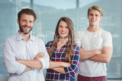 Portrait of executives standing with arms crossed