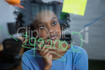 Female graphic designer looking at the glass
