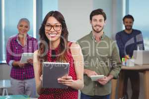 Portrait of business executives using digital tablet