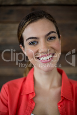 Smiling female business executive standing in office