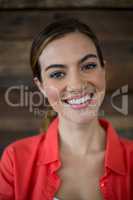 Smiling female business executive standing in office