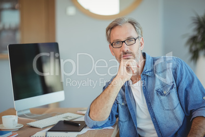 Portrait of graphic designer sitting at desk