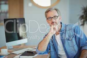 Portrait of graphic designer sitting at desk
