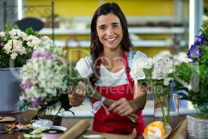 Florist offering flowers at the counter in the florist shop