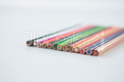 Colored pencils arranged in a row