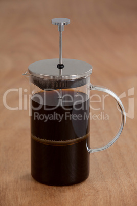 Cafetiere on wooden background