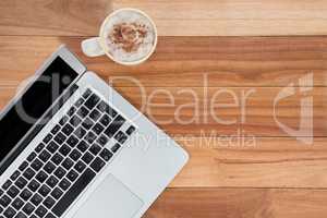 Mug of coffee and laptop