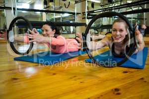 Fit women exercising with pilates ring