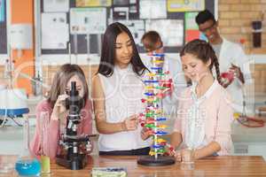 Group of students experimenting molecule model in laboratory