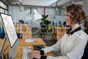 Female graphic designer using desktop pc