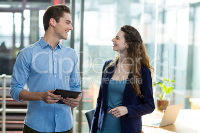 Business executives interacting with each other in office