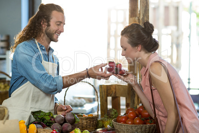 Woman smelling strawberries at the counter