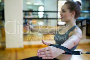 Woman practicing stretching exercise on reformer
